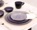 Hand painted dinnerware set with floral patterns on a wooden table