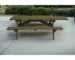 Green solid wood folding dining table set up outdoors with benches for 8 people