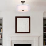 Goldoma modern fabric pendant light with three bulbs, hanging above a wooden dining table in a bright living room.