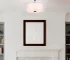 Goldoma modern fabric pendant light with three bulbs, hanging above a wooden dining table in a bright living room.