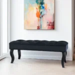 Mid-century velvet ottoman with wood legs in black - Goldoma