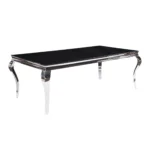 Black and white glass dining table with stainless steel base in modern home
