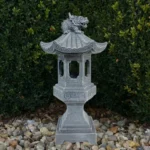 Solar pagoda lantern glowing in a garden at dusk, surrounded by flowers