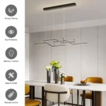 Remote control for the LED chandelier placed next to the light fixture on a white surface.