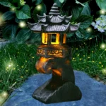 Solar pagoda lantern glowing near a koi pond, reflecting light on water surface.