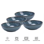 Set of six organic stoneware dinner plates with irregular edges and reactive glaze on a wooden table