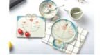 Japanese ceramic dinnerware set with hand-drawn cat design on blue rectangular plate and bowl