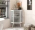 Goldoma corner cabinet with glass door in living room displaying decor items on shelves