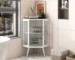 Goldoma corner cabinet with glass door in living room displaying decor items on shelves