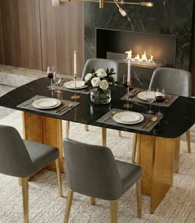 Modern glass dining table set with marble pattern and gold metal legs in a dining room setting