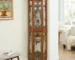 Lighted corner curio cabinet with glass shelves and door, showcasing collectibles