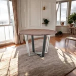 48-inch round two tone dining table with brown wood top and black iron sled base in a dining room setting