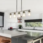 Close-up of brushed nickel finish and clear glass shades on the contemporary chandelier.
