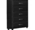 Modern black glass dresser with silver bar pulls in a stylish bedroom