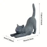 Hand-painted stretching cat statue in garden setting