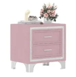 Modern velvet nightstand with silver glitter strip decor and two drawers, placed beside a bed in a bedroom