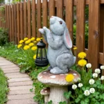 Close-up of the resin bunny figurine showing textured brown fur and solar panel on its back.