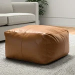 Goldoma 22 inch tan genuine leather pouf ottoman as a footrest