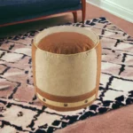 Goldoma 16 inch tan cotton striped cylinder pouf ottoman used as footrest in living room