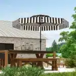 Black patio umbrella with tilt mechanism in outdoor setting