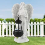 Artistic angel-shaped resin lantern statue with warm LED glow, placed on garden table.