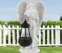 Angel lantern statue glowing in garden at dusk
