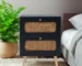 Minimalist bedside table with two handwoven rattan drawers in a bright bedroom