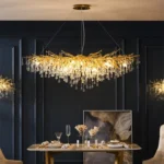 Modern crystal chandelier with brass and black finish illuminating a living room
