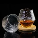 Set of hazy wine glasses with hammer pattern and snowflake design on a wooden table