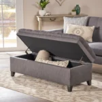Purple fabric storage ottoman with hidden compartment and birch wood legs in a living room
