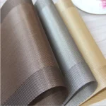 Gold weave placemats on a dining table with plates and cutlery