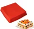 Square silicone cake mold with baked cake inside on cooling rack