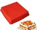 Square silicone cake mold with baked cake inside on cooling rack