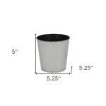 Large silver planter with a thriving houseplant on a modern table