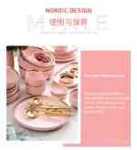 Elegant dinnerware set with gilt rim pink porcelain plates, bowls, mugs, and cutlery on a table