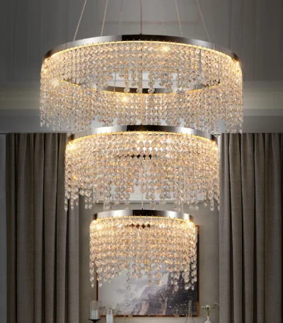 Modern 3-layer round K9 crystal pendant chandelier with 55W LED light, hanging in a foyer with warm glow.