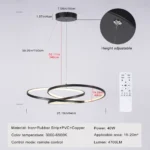 Close-up of the black chandelier showing the sleek, circular LED panel and the remote control placed on a marble