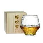 Set of hazy wine glasses with hammer pattern and snowflake design on a wooden table