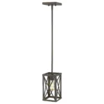 Bronze metal mini chandelier suspended over a modern living room coffee table, soft ambient lighting.
