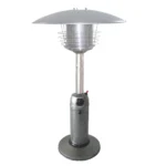 Side view of Goldoma tabletop gas heater showing silver steel body and control knob, set on a wooden patio table.