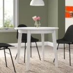 Goldoma 36-inch round dining table with white wood top and sintered stone finish, showcasing industrial design in a home dining setting