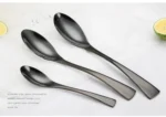 Luxury black 18/10 stainless steel cutlery set arranged on a table