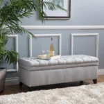 Purple fabric storage ottoman with hidden compartment and birch wood legs in a living room