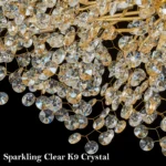 Modern crystal chandelier tree branch design illuminating a dining room