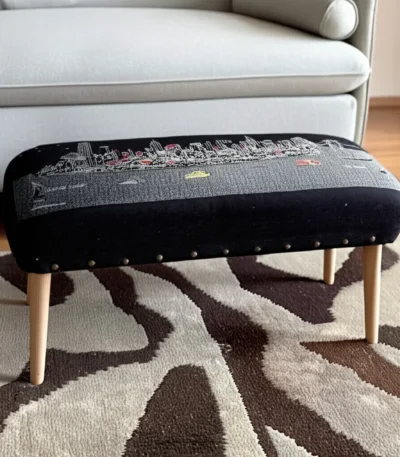Goldoma gray wool ottoman with brown legs and hidden storage, featuring nailhead trim