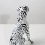Boxer dog statue on a side table, colorful accent piece.