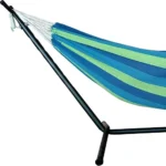 Two person hammock with stand in blue and green stripes on a sunny patio