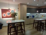Modern 6-seater dining table with black MDF frame, gold legs, and tempered glass top in a contemporary dining room setting