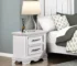 White nightstand with drawers featuring black handles and two spacious drawers