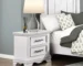 White nightstand with drawers featuring black handles and two spacious drawers